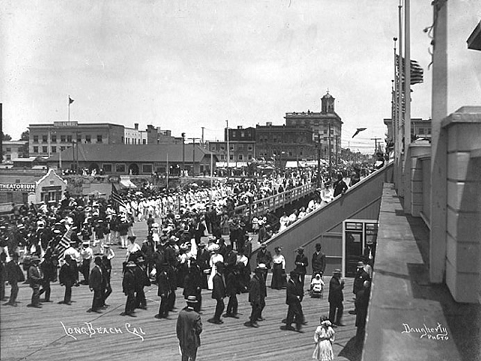 1915 photo of parade on pier with Theatorium in background
