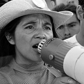 Dolores Huerta shouting into a megaphone